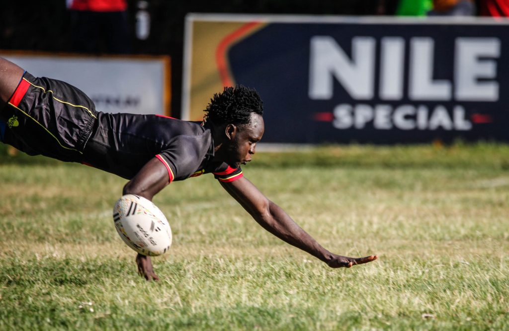 Rugby player diving over after scoring a goal